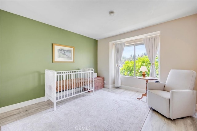 53 Briarwood Ln Unit 81, Aliso Viejo, CA 92656 - bedroom with wood finished floors and a crib