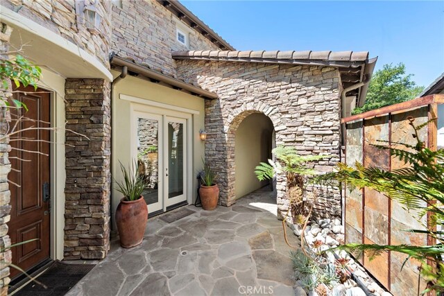 4 Dennis Ln, Ladera Ranch, CA 92694 - property entrance featuring stone siding and french doors