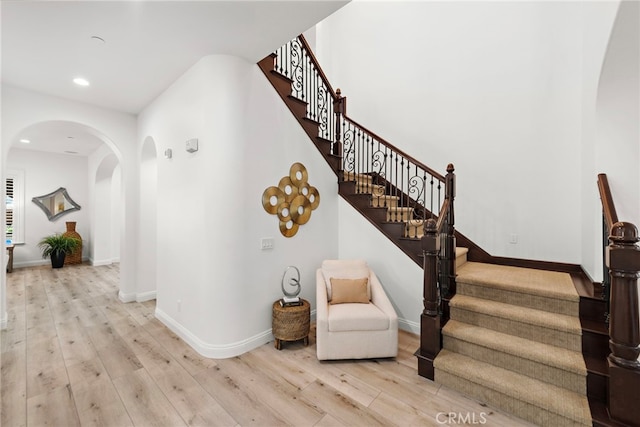 4 Dennis Ln, Ladera Ranch, CA 92694 - stairway featuring arched walkways, wood finished floors, and recessed lighting