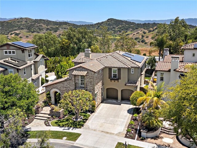 4 Dennis Ln, Ladera Ranch, CA 92694 - view of front of home featuring a chimney, concrete driveway, a tile roof, and an attached garage