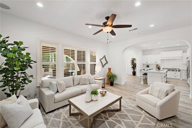 4 Dennis Ln, Ladera Ranch, CA 92694 - living room with arched walkways, ceiling fan, light wood-style flooring, recessed lighting, and baseboards