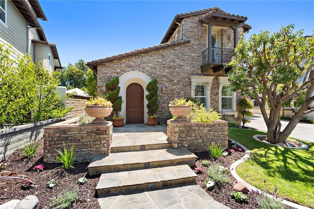 4 Dennis Ln, Ladera Ranch, CA 92694 - view of front facade with stone siding, a balcony, and a tiled roof