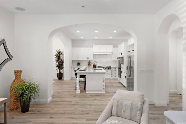 4 Dennis Ln, Ladera Ranch, CA 92694 - living area featuring light wood-style floors, recessed lighting, and arched walkways
