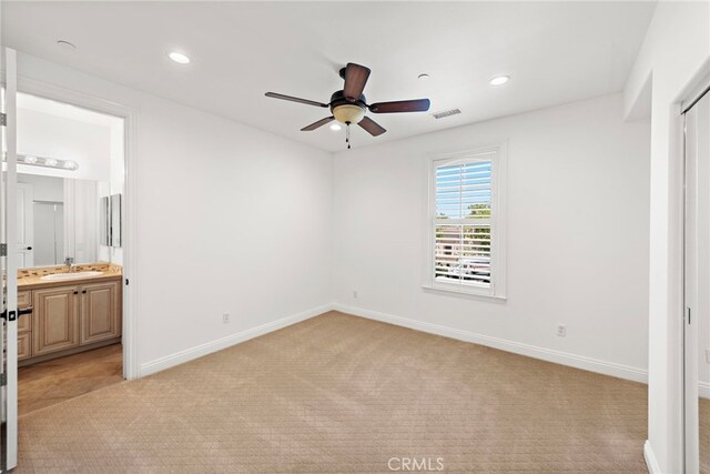 4 Dennis Ln, Ladera Ranch, CA 92694 - unfurnished bedroom featuring a sink, light carpet, baseboards, recessed lighting, and ensuite bathroom