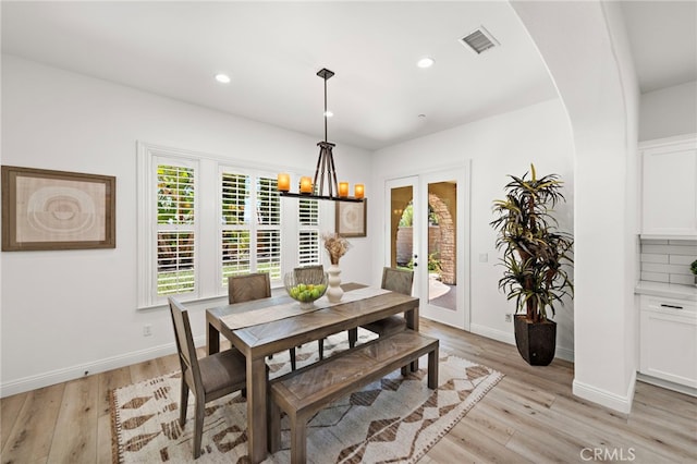 4 Dennis Ln, Ladera Ranch, CA 92694 - dining area featuring french doors, light wood-style flooring, arched walkways, a chandelier, and recessed lighting