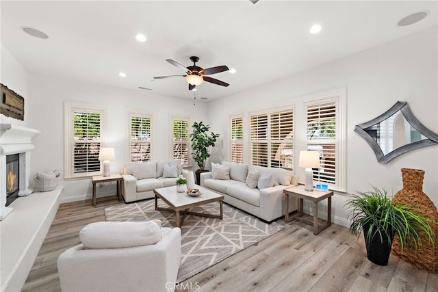 4 Dennis Ln, Ladera Ranch, CA 92694 - living area featuring a ceiling fan, light wood-style flooring, recessed lighting, and a glass covered fireplace