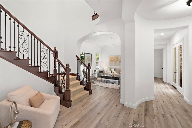 4 Dennis Ln, Ladera Ranch, CA 92694 - foyer featuring arched walkways, hardwood / wood-style floors, baseboards, and stairway