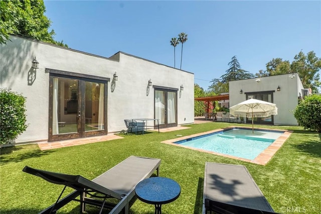 11101 Blix St, Toluca Lake, CA 91602 - back of property with french doors, a lawn, an outdoor pool, and stucco siding