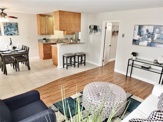 1039 E Appleton St Unit 2, Long Beach, CA 90802 - living area featuring a ceiling fan and baseboards