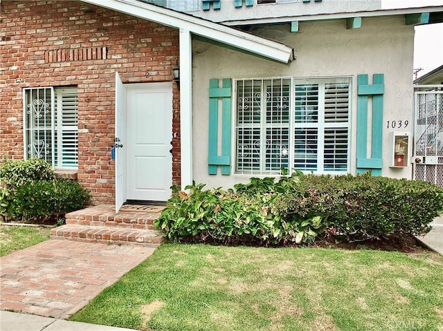1039 E Appleton St Unit 2, Long Beach, CA 90802 - entrance to property with brick siding, a yard, and stucco siding