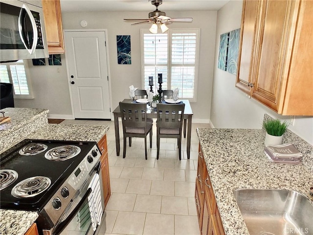 1039 E Appleton St Unit 2, Long Beach, CA 90802 - kitchen featuring stainless steel appliances, a ceiling fan, light stone countertops, brown cabinets, and a sink
