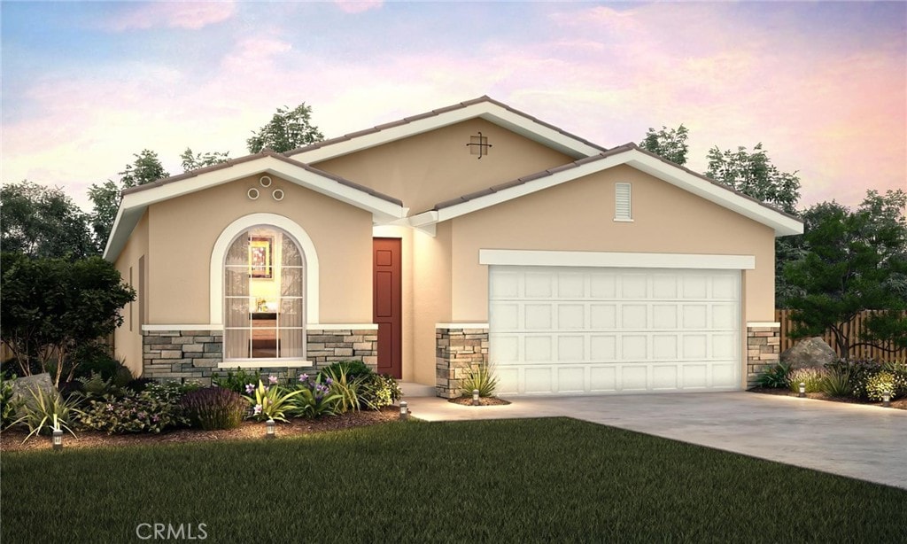 824 Jovan Ct, Merced, CA 95348 - view of front of home with stone siding, stucco siding, concrete driveway, a garage, and a lawn