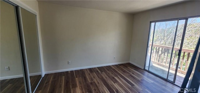 5580 Traffic Way Unit 3, Atascadero, CA 93422 - unfurnished bedroom featuring dark wood-style flooring, baseboards, access to outside, and a closet