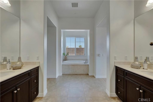 13691 Cobalt Ct, Rancho Cucamonga, CA 91739 - bathroom featuring two vanities, a garden tub, tile patterned floors, and baseboards