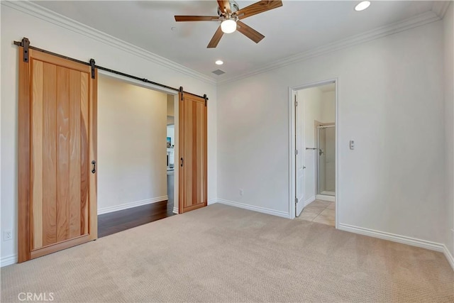 13691 Cobalt Ct, Rancho Cucamonga, CA 91739 - unfurnished bedroom with a barn door, carpet floors, ornamental molding, recessed lighting, and baseboards