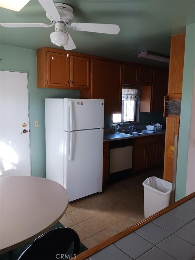 5155 W 104th St, Inglewood, CA 90304 - kitchen with freestanding refrigerator, light tile patterned flooring, a ceiling fan, a sink, and brown cabinets