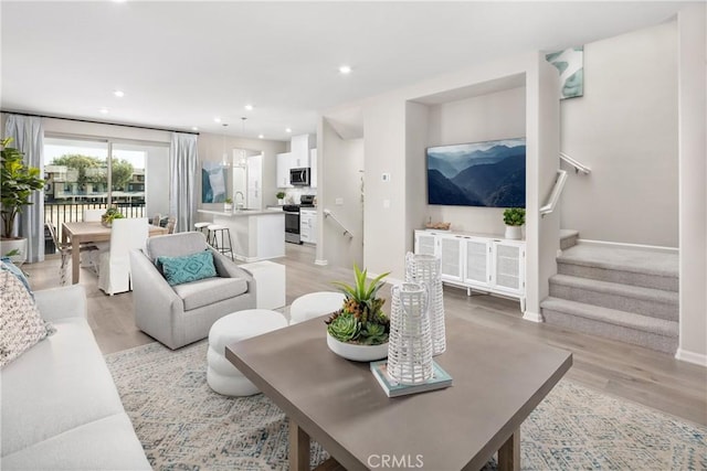 16359 Meadowhouse Ave, Chino, CA 91708 - living area featuring light wood-type flooring, stairs, recessed lighting, and baseboards