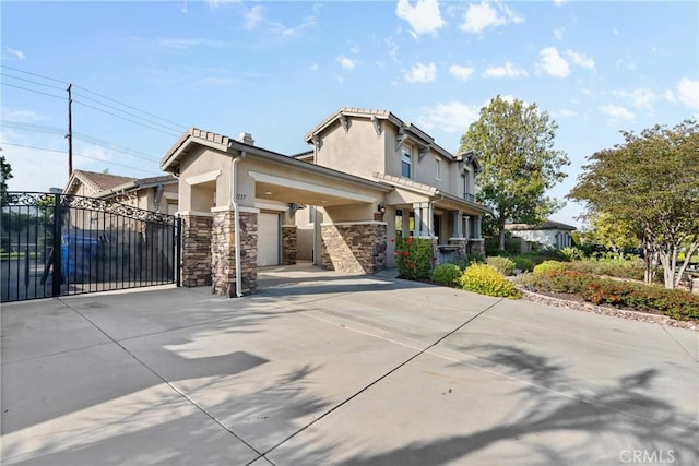 1137 Pamplona Dr, Riverside, CA 92508 - view of front of house with driveway, an attached garage, stucco siding, stone siding, and a gate