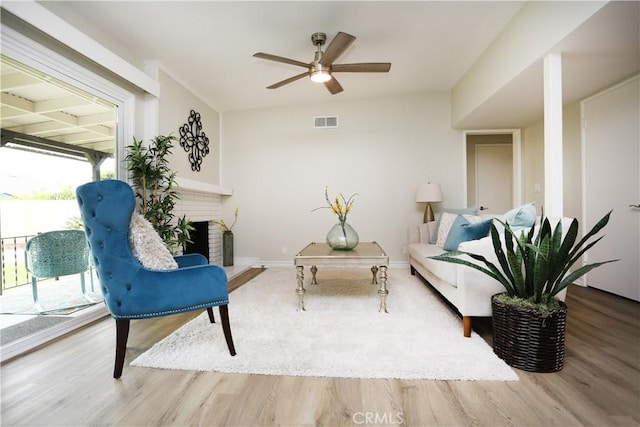 321 S Beachy Pl, Anaheim, CA 92804 - living area featuring ceiling fan, wood finished floors, a brick fireplace, and baseboards