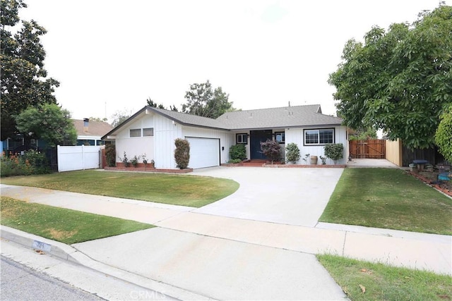 321 S Beachy Pl, Anaheim, CA 92804 - ranch-style home with an attached garage, driveway, board and batten siding, and a gate