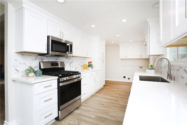 321 S Beachy Pl, Anaheim, CA 92804 - kitchen with stainless steel appliances, a sink, baseboards, recessed lighting, and light wood-style floors