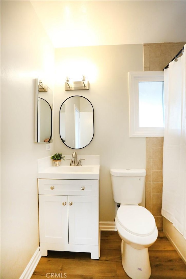 321 S Beachy Pl, Anaheim, CA 92804 - bathroom with toilet, vanity, wood finished floors, baseboards, and a shower with curtain