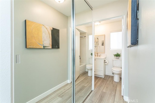33772 Copper Lantern St Unit B, Dana Point, CA 92629 - bathroom with toilet, vanity, wood finished floors, shower / bath combination, and baseboards
