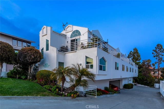 33772 Copper Lantern St Unit B, Dana Point, CA 92629 - view of property exterior with stucco siding, a garage, and driveway