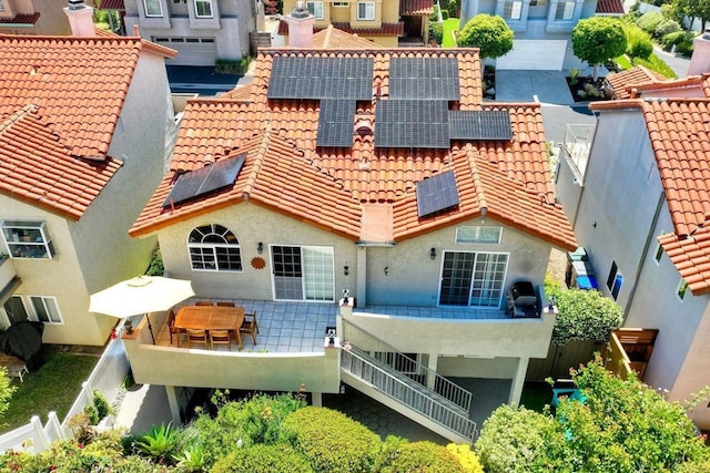 232 Hygeia Ct, Encinitas, CA 92024 - back of property featuring a tiled roof, roof mounted solar panels, and stucco siding