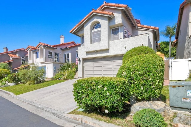 232 Hygeia Ct, Encinitas, CA 92024 - mediterranean / spanish home with an attached garage, a tiled roof, stucco siding, a gate, and concrete driveway