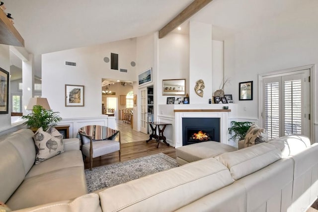 232 Hygeia Ct, Encinitas, CA 92024 - living area featuring high vaulted ceiling, a lit fireplace, plenty of natural light, wood finished floors, and beamed ceiling