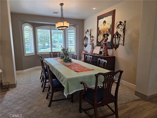 42036 Desert Sage Ave, Lancaster, CA 93536 - dining area with a chandelier, baseboards, and light wood-type flooring