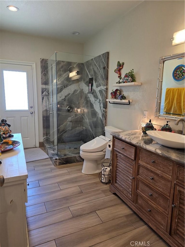 42036 Desert Sage Ave, Lancaster, CA 93536 - bathroom featuring vanity, a marble finish shower, toilet, wood finished floors, and recessed lighting