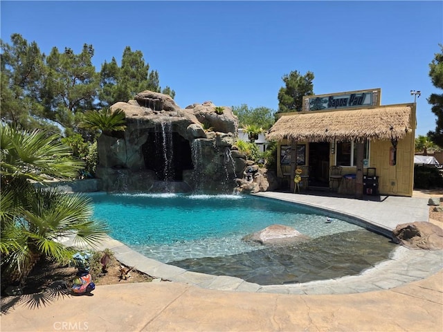 42036 Desert Sage Ave, Lancaster, CA 93536 - swimming pool with a storage structure, an outdoor structure, and a patio