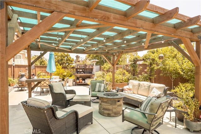8340 Rosemary Dr, Riverside, CA 92508 - fenced backyard featuring an outdoor living space with a fireplace, a patio, and a pergola