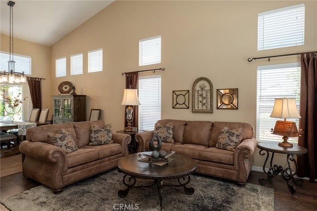 8340 Rosemary Dr, Riverside, CA 92508 - living area with high vaulted ceiling, wood finished floors, healthy amount of natural light, and a chandelier