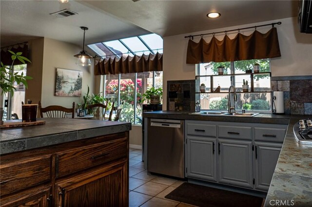 8340 Rosemary Dr, Riverside, CA 92508 - kitchen featuring dishwasher, a sink, light tile patterned floors, decorative light fixtures, and tasteful backsplash