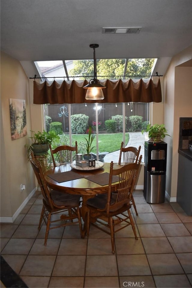 8340 Rosemary Dr, Riverside, CA 92508 - dining room with light tile patterned floors, baseboards, a skylight, and lofted ceiling