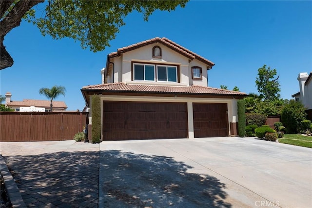 8340 Rosemary Dr, Riverside, CA 92508 - mediterranean / spanish-style house with an attached garage, concrete driveway, stucco siding, and a tiled roof