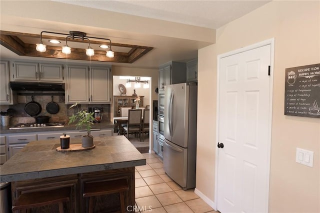 8340 Rosemary Dr, Riverside, CA 92508 - kitchen featuring appliances with stainless steel finishes, under cabinet range hood, dark countertops, and gray cabinets