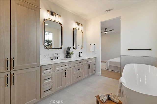 5539 Erin Way, Paradise, CA 95969 - bathroom featuring double vanity, a soaking tub, a ceiling fan, and baseboards