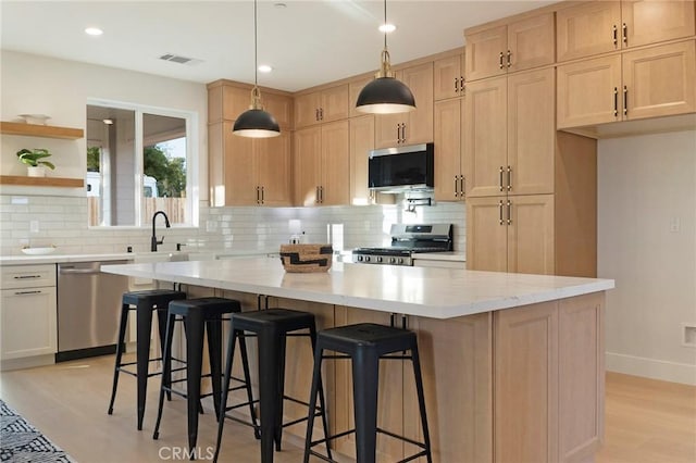 5539 Erin Way, Paradise, CA 95969 - kitchen featuring appliances with stainless steel finishes, backsplash, a center island, light brown cabinets, and recessed lighting