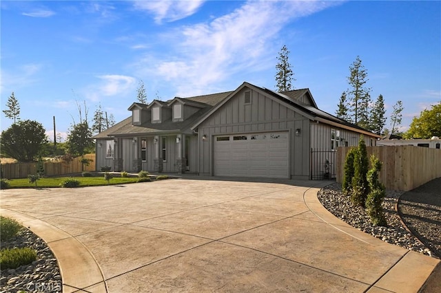 5539 Erin Way, Paradise, CA 95969 - view of front of home with board and batten siding, concrete driveway, and a garage