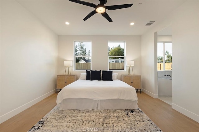 5539 Erin Way, Paradise, CA 95969 - bedroom featuring baseboards, multiple windows, light wood-style floors, and recessed lighting
