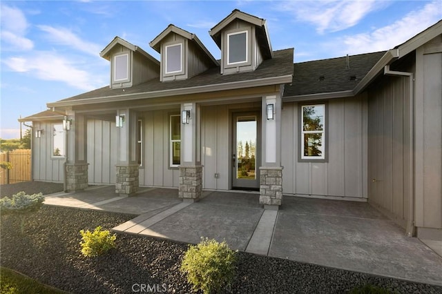 5539 Erin Way, Paradise, CA 95969 - doorway to property featuring board and batten siding, roof with shingles, and a patio area