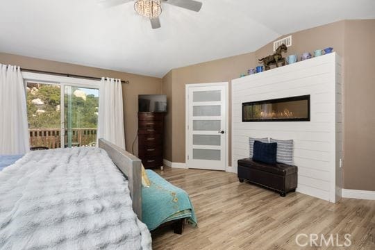 41350 Calle Bandido, Murrieta, CA 92562 - bedroom with lofted ceiling, baseboards, access to outside, wood finished floors, and ceiling fan