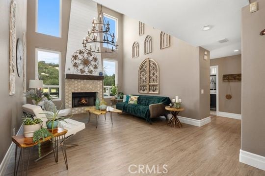 41350 Calle Bandido, Murrieta, CA 92562 - sitting room with baseboards, wood finished floors, a chandelier, and a fireplace