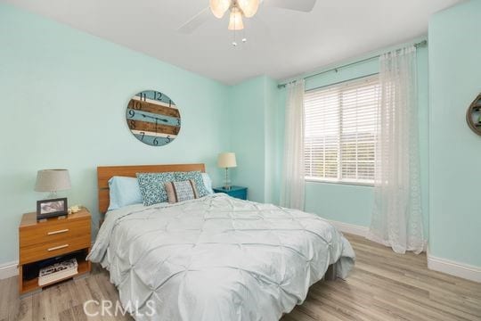 41350 Calle Bandido, Murrieta, CA 92562 - bedroom with baseboards, wood finished floors, and a ceiling fan