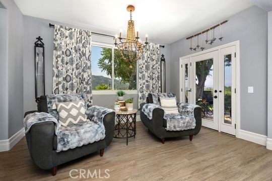 41350 Calle Bandido, Murrieta, CA 92562 - living area with a chandelier, wood finished floors, and baseboards