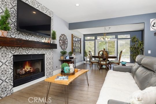 41350 Calle Bandido, Murrieta, CA 92562 - living area with wood finished floors, baseboards, a tiled fireplace, and recessed lighting
